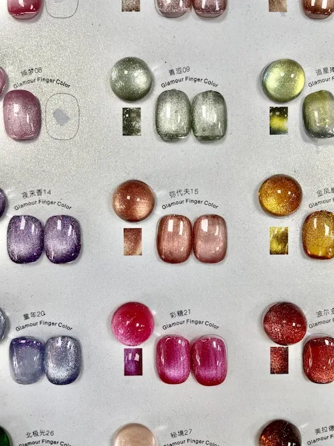 Cat eye gel colour chart at a Japanese nail salon in Williamsburg Brooklyn, showing magnetic shimmer swatches