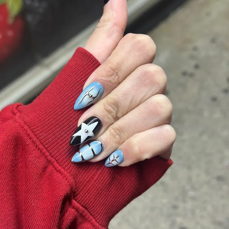 Blue nails with star and character art by Tina Green Nail