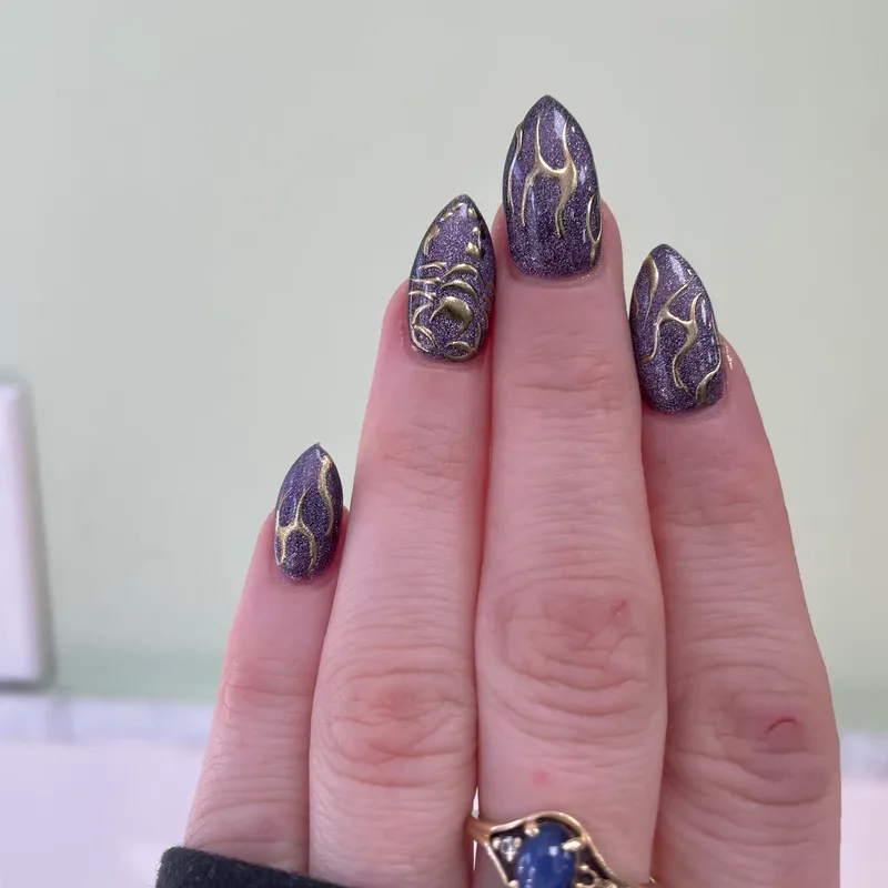 Purple cat-eye nails with gold flame art by Tina Green Nail