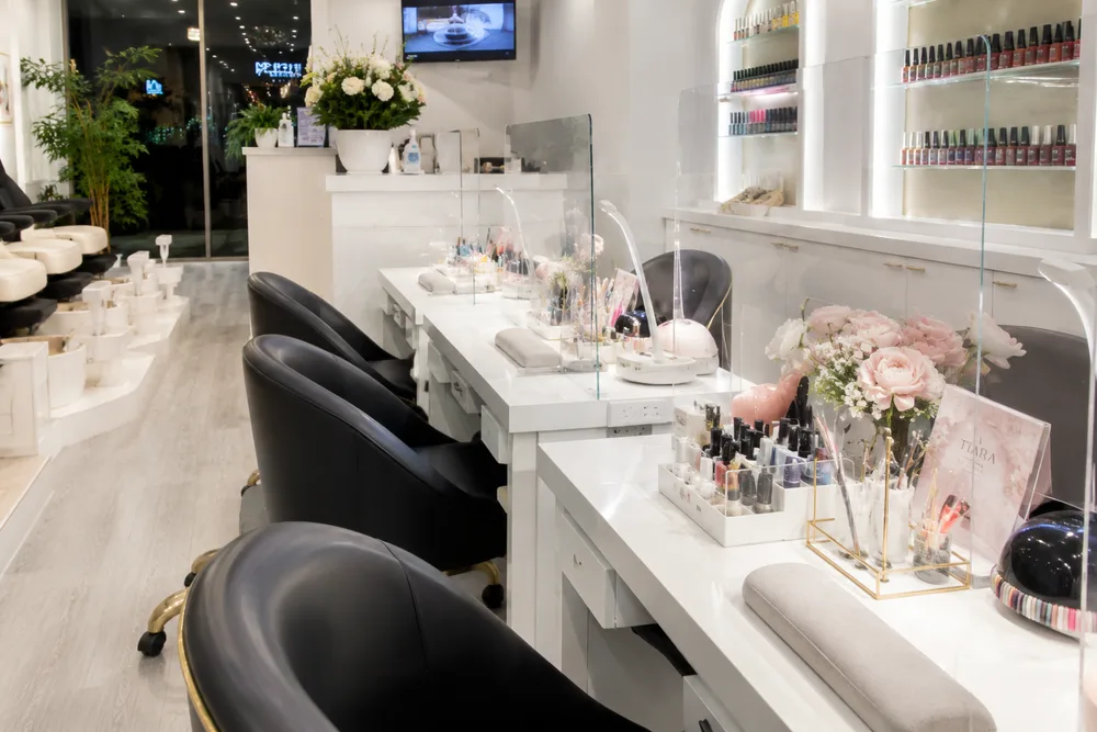 Inside the Tina Green Nail salon — manicure stations and polish wall